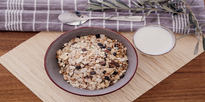 A bowl of oatmeal and a glass of milk